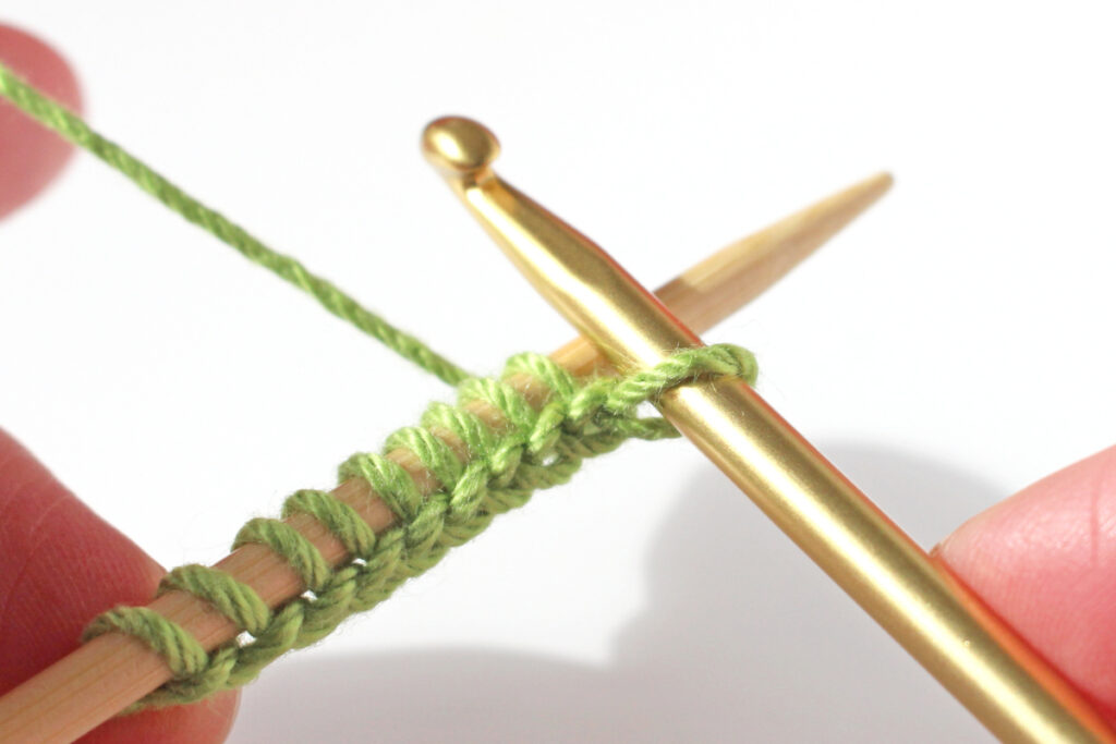 Carry casting-on new stitches until you have one fewer than required