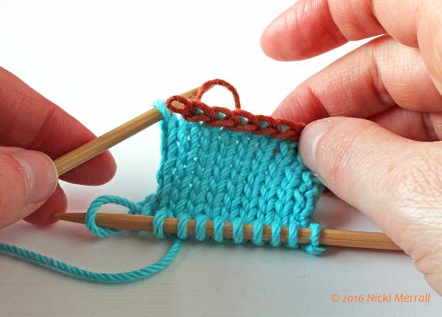 Carefully remove first stitch in waste yarn