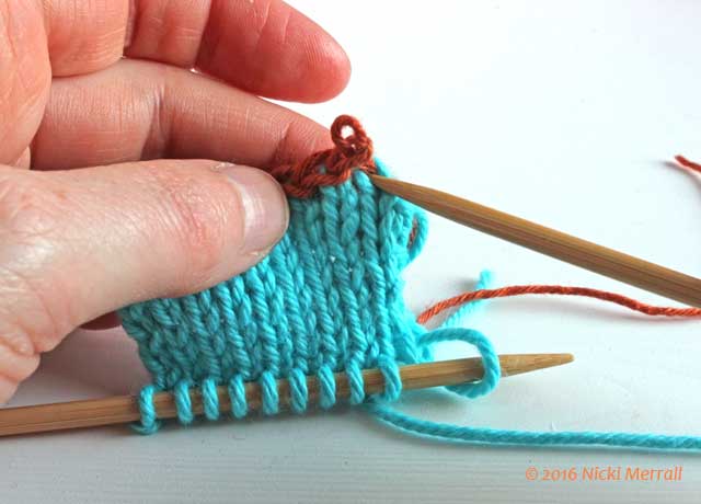 Insert knitting needle into first loop of working yarn
