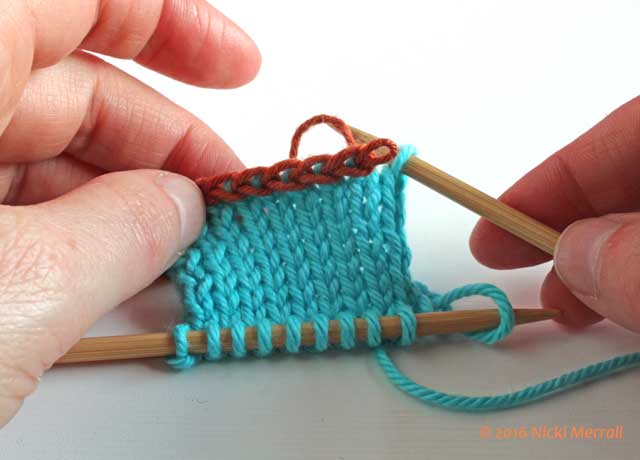 Carefully remove first stitch in waste yarn