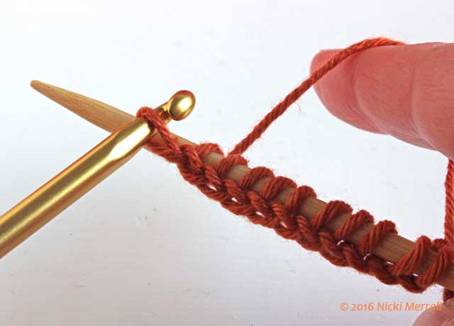 Continue casting on stitches in waste yarn until you have required number