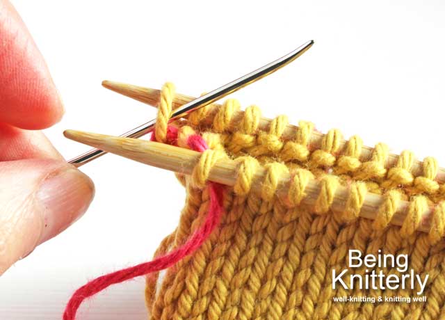 Step 10: Pass yarn needle purlwise through first stitch on back needle