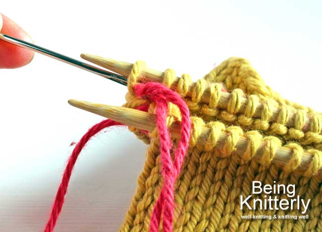 Step 12: Pass yarn needle knitwise through next stitch on back needle