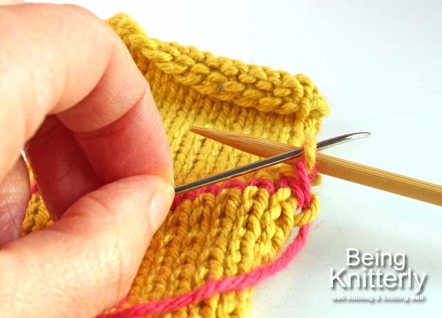 Step 15: Pass yarn needle purlwise through last stitch on back needle and slip stitch off needle