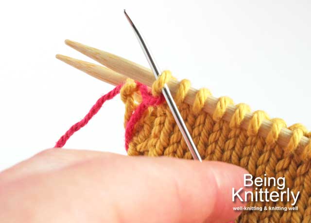 Step 6: Pass yarn needle knitwise through first stitch on front needle.