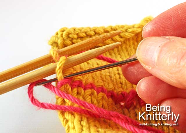 Finishing step 1: Pass yarn needle knitwise through last stitch on front needle and slip off needle