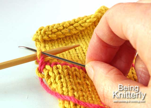 Finishing step 2: Pass yarn needle purlwise through last stitch on back needle and slip stitch off needle