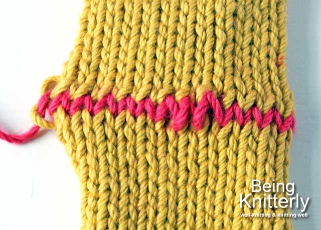 Neating grafted stitches use yarn needle to ease yarn along row so tension of sewn stitches matches that of knitted stitches