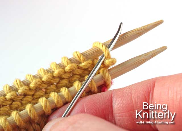 Set-up step 2a: Pass yarn needle knitwise through first stitch on the back needle