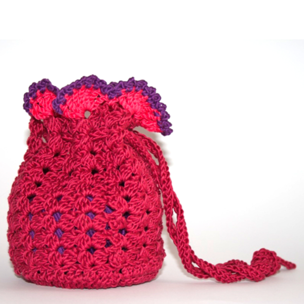 Deep pink crochet bag with a drawstring and a bright pink and purple frill