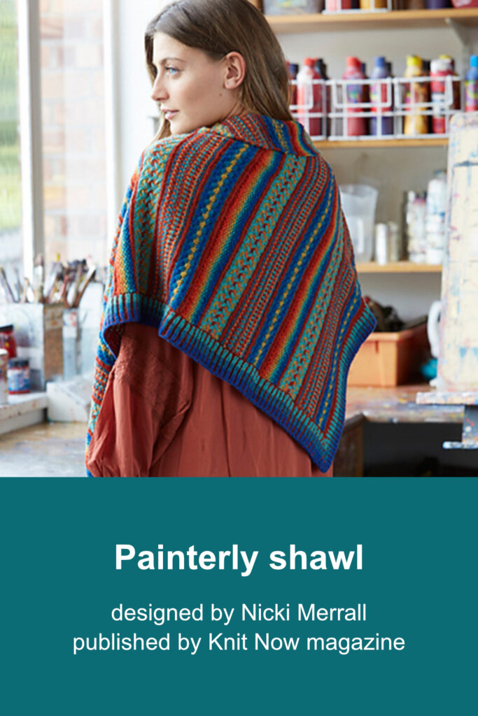 Woman wearing asymmetric triangular shawl worked from single point to shortest edge by increasing along one side. Two shorter sides are finished with brioche rib