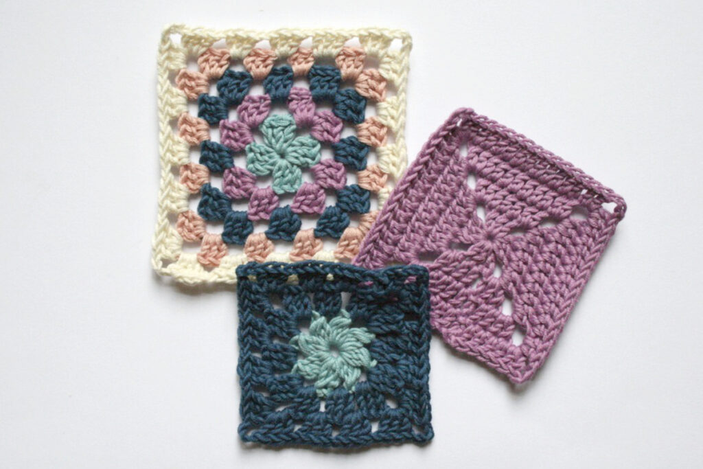 Three granny squares: one is a traditional granny square and the other two are variations of this.