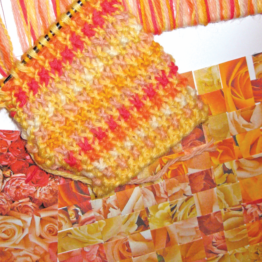 Colour confidence–colourful hand-knit sample with the photo of roses that inspired the colours used, a yarn wrap and a paper weave