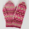 Hand-knitted Fair Isle style mittens in shades of pink with large flower motif on back and small patterns on palm and thumbs