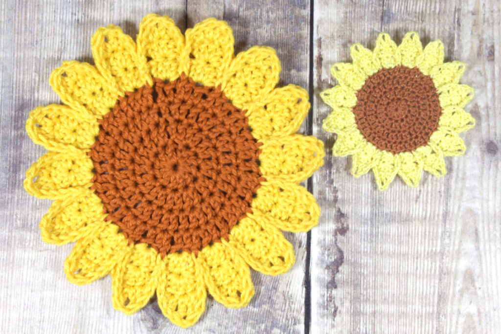 Two crochet sunflowers; one is larger than the other